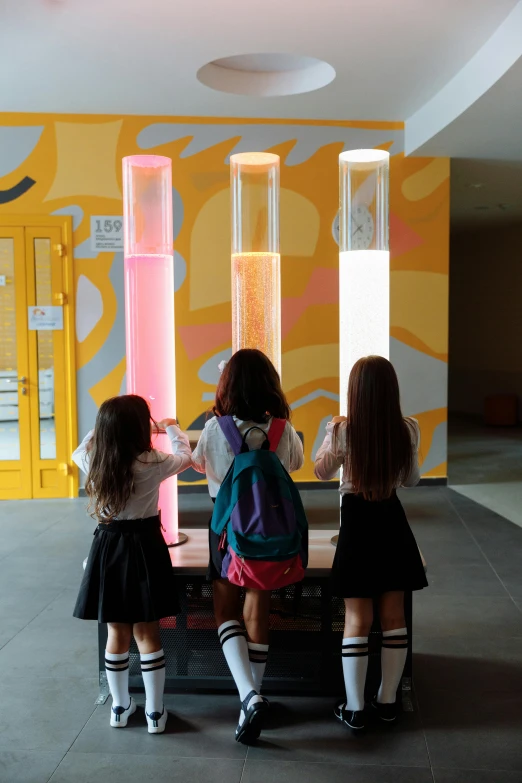 a group of young girls standing next to each other, by Hirosada II, interactive art, iridescent tubes, schools, museum light, panels