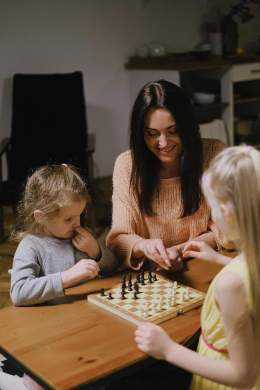 a woman and two children playing a game of chess, by Adam Marczyński, pexels contest winner, square, 15081959 21121991 01012000 4k, scene from a movie, thumbnail