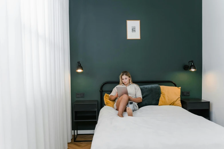 a little girl sitting on top of a bed, inspired by Elsa Bleda, pexels contest winner, happening, dark green color scheme, mid 2 0's female, hotel room, medium height