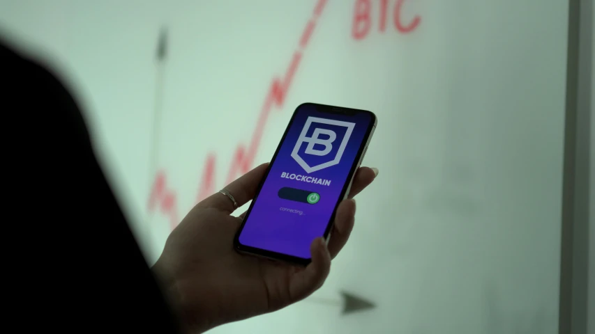 a close up of a person holding a cell phone, blockchain, square, hq ”, b