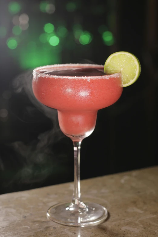 a close up of a drink in a glass on a table, la catrina, cosmopolitan, frosty, black on red