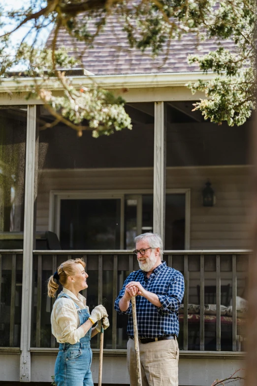 a man and a woman standing in front of a house, overalls and a white beard, gardening, profile image, cottagecore