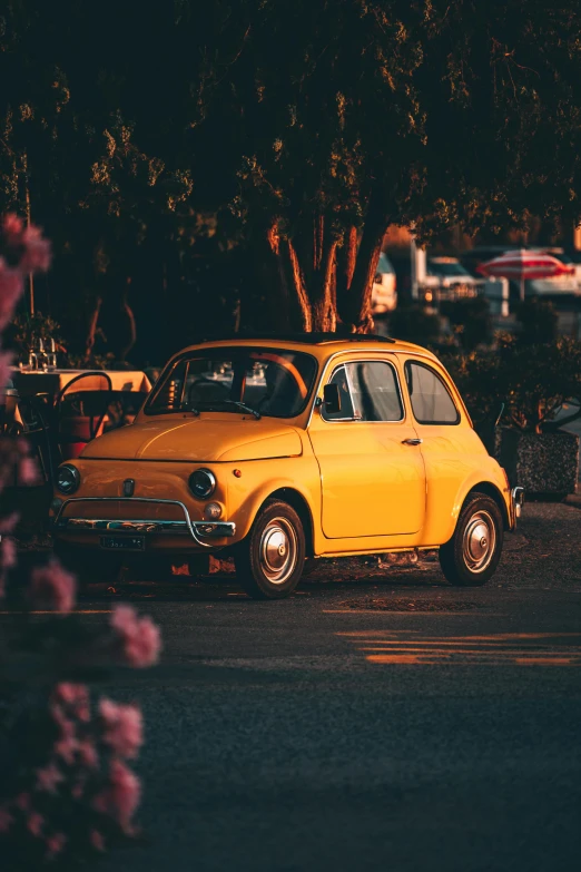 a small yellow car parked in a parking lot, pexels contest winner, renaissance, spring evening, italian style, square, bumblebee