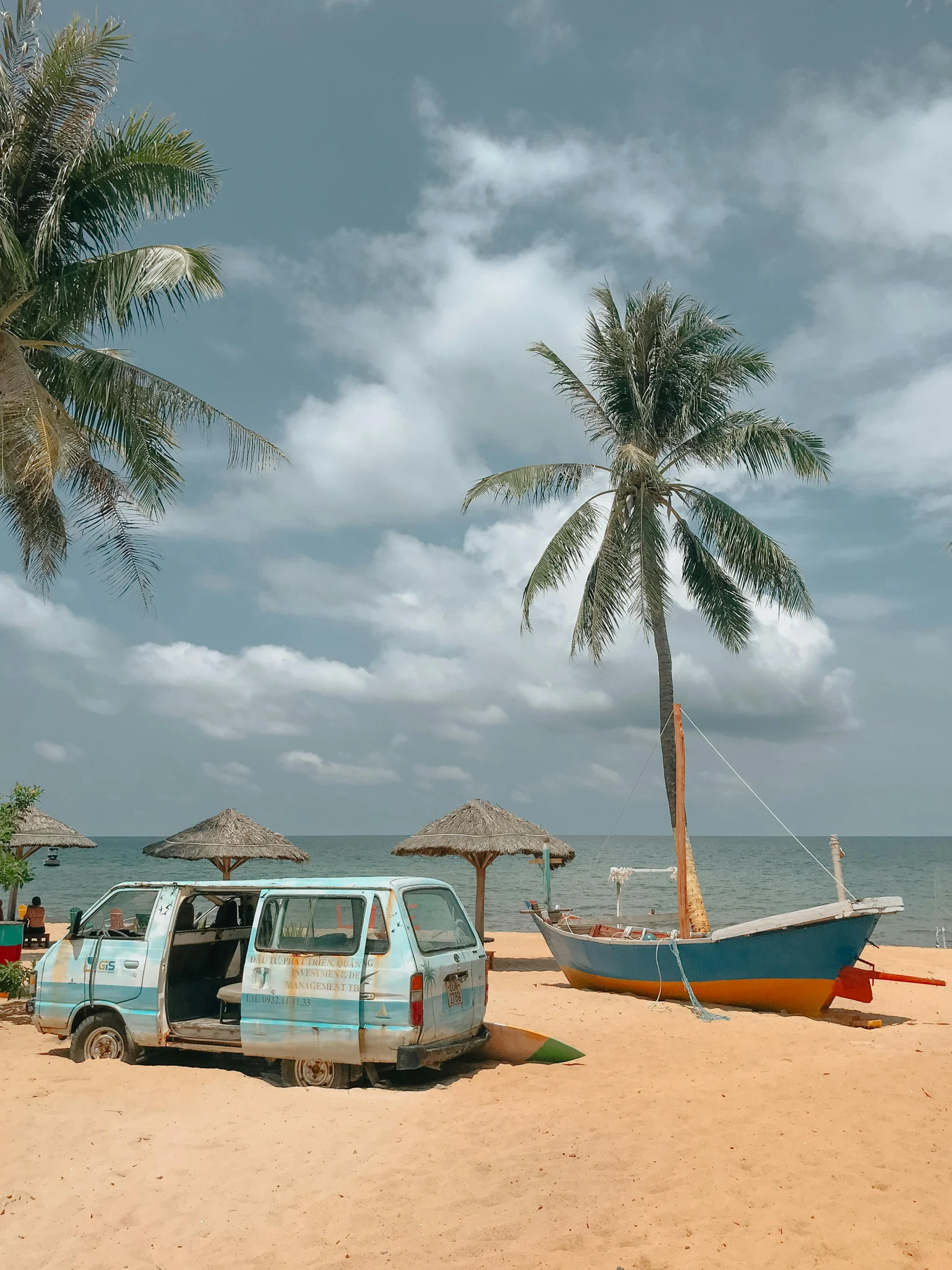 a van parked on top of a sandy beach, coconut trees, fishing village, profile image