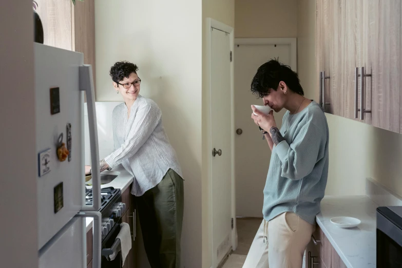 a man standing next to a woman in a kitchen, by Carey Morris, pexels contest winner, adrian tomine, dwell, waking up, set photo