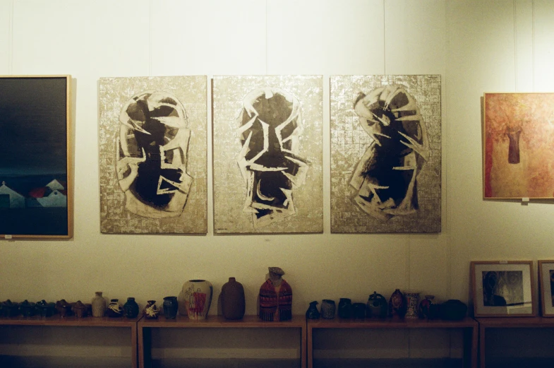 a couple of paintings hanging on the side of a wall, by Sigrid Hjertén, mingei, pottery, 1990 photograph, triptych, indigenous art