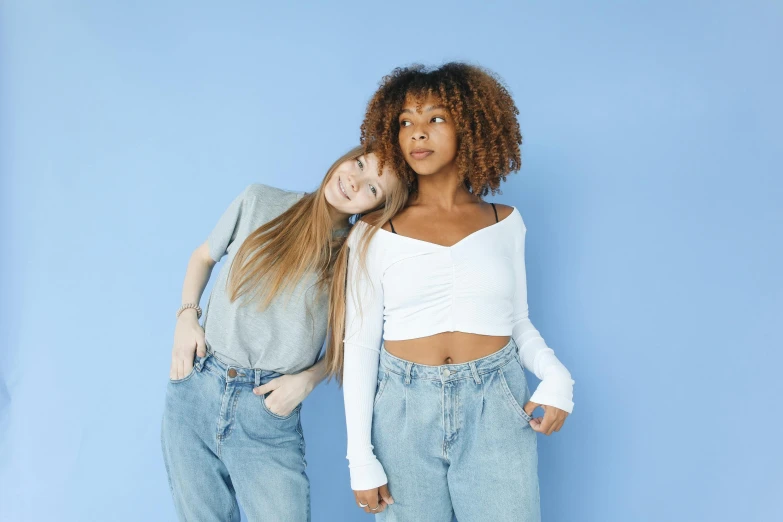 a couple of women standing next to each other, trending on pexels, renaissance, croptop, white and pale blue, black teenage girl, diverse ages