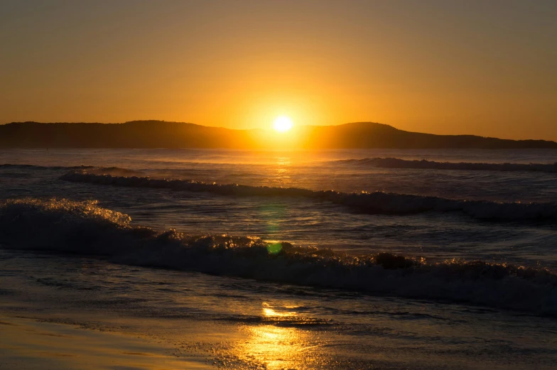 the sun is setting over the water on the beach, by Andrew Allan, pexels contest winner, liquid gold, full morning sun, mount, 1 2 9 7