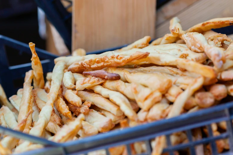 a basket full of french fries sitting on top of a table, toronto, festivals, close up of lain iwakura, exterior shot