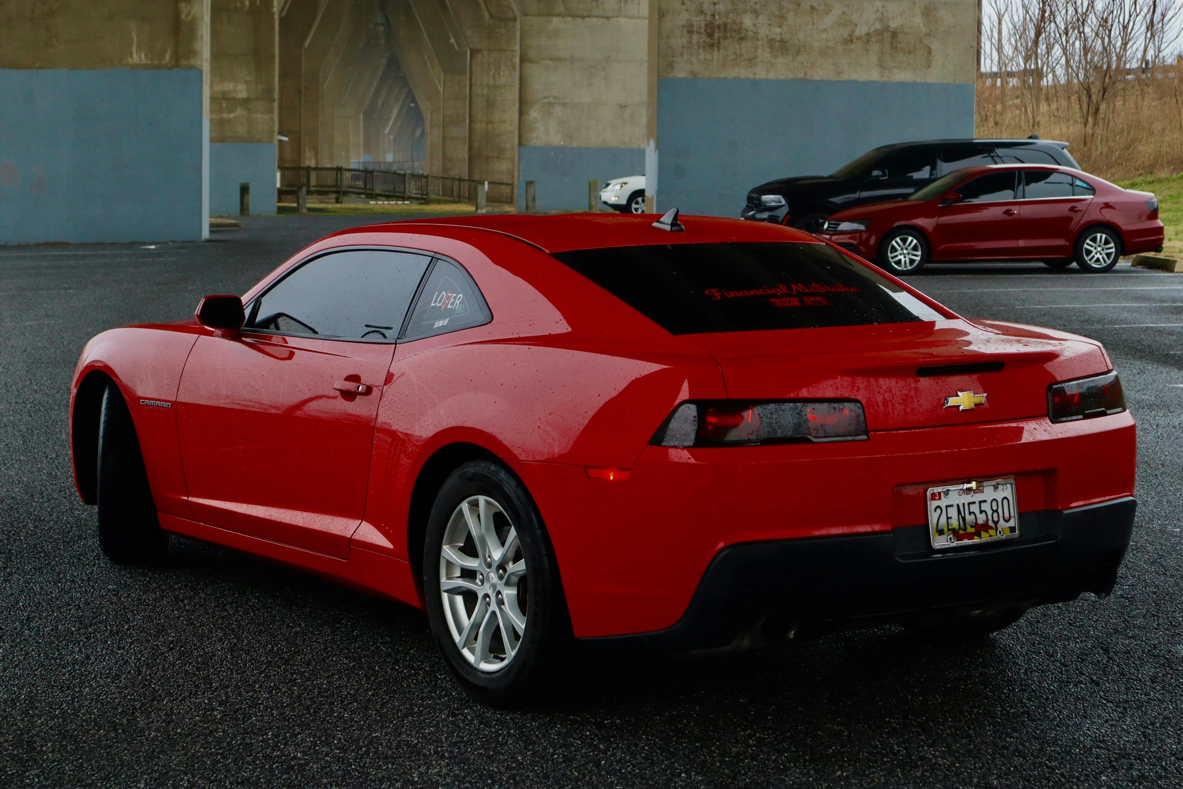 a red sports car parked in a parking lot, by Carey Morris, pexels contest winner, photorealism, front back view and side view, 4k highly detailed, red shirt, gm