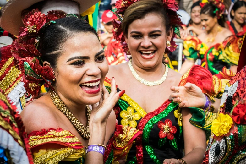 a group of women standing next to each other, by Sam Dillemans, pexels contest winner, happening, carnaval de barranquilla, she is smiling and excited, woman holding another woman, philippines