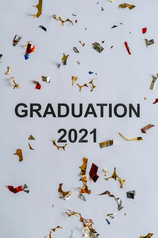 a sign that says graduation 2021 surrounded by confetti, a picture, by Carey Morris, trending on pexels, high gradient, curated collections, top 1 0 0, embroidered robes