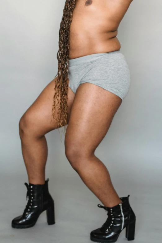 an image of a woman posing for a picture, gray shorts and black socks, showing curves, grey skinned, promo image