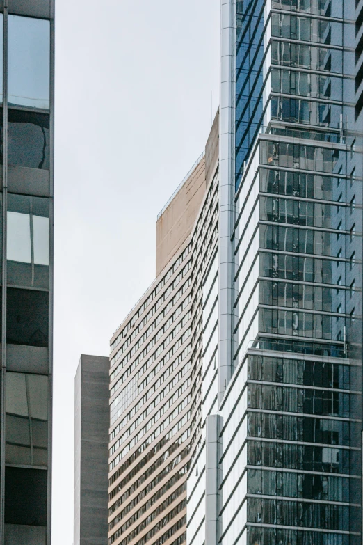 a couple of tall buildings next to each other, modernism, high-body detail, street level view, fan favorite, glass openings