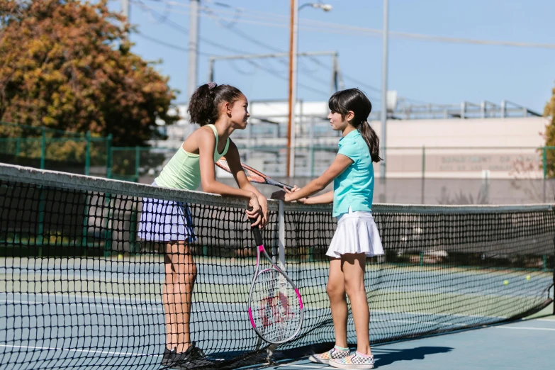 two young girls shaking hands on a tennis court, a portrait, by Meredith Dillman, shutterstock, vine, profile image, san francisco, little