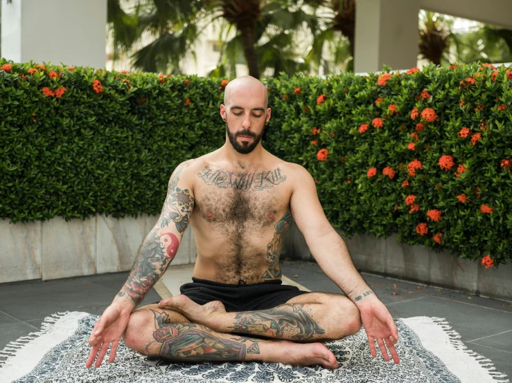 a man sitting in the middle of a yoga pose, a portrait, by Jessie Alexandra Dick, with tattoos, sitting on a lotus flower, featured, elias chatzoudis