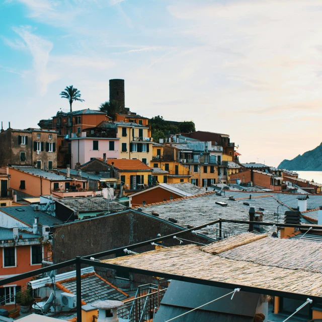 a number of buildings near a body of water, pexels contest winner, renaissance, roofs, cinq terre, sunfaded, rooftop party