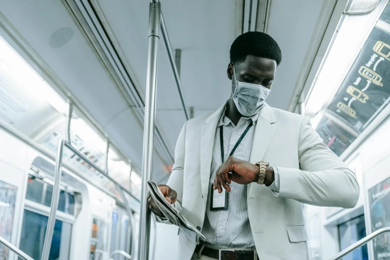 a man wearing a face mask on a subway, pexels contest winner, afrofuturism, wearing a white lab coat, holding a clipboard, intricate suit, thumbnail