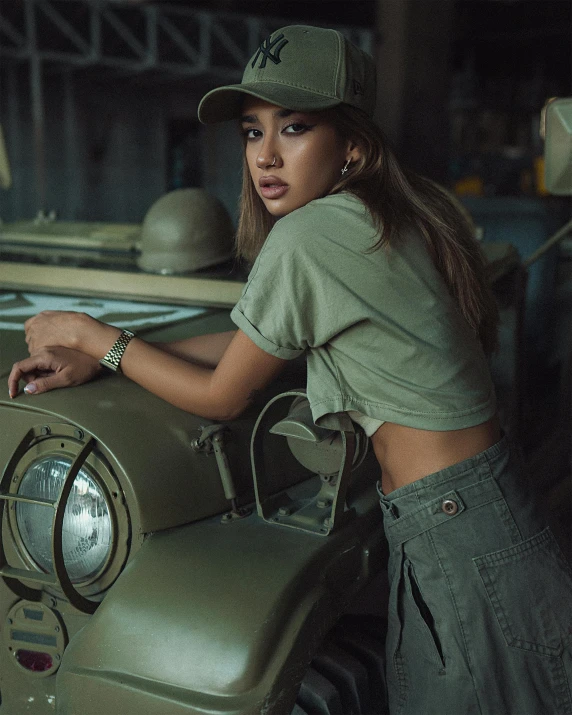 a woman leaning on the hood of a jeep, a colorized photo, inspired by Natasha Tan, trending on pexels, girl wearing uniform, vanessa morgan, muted green, studio photoshoot