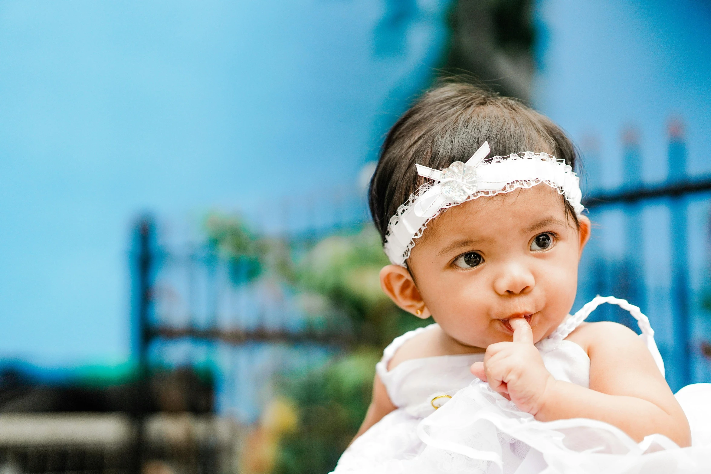 a baby girl wearing a white dress and a white headband, pexels contest winner, complex background, alanis guillen, essence, tiny mouth