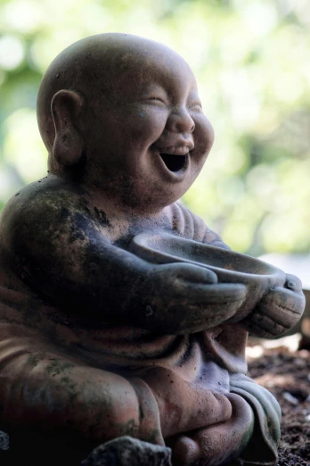 a statue of a laughing buddha sitting on the ground, inspired by Tani Bunchō, unsplash, mingei, medium closeup, cherub, eating, pot