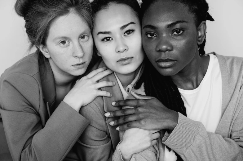 three women pose for a black and white photo, by Emma Andijewska, mix of ethnicities and genders, louise zhang, adut akech, woman holding another woman