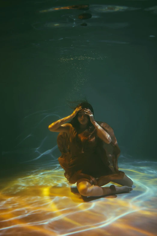 a woman sitting on the ground in the water, unsplash contest winner, conceptual art, light show, concerned, ignant, sza