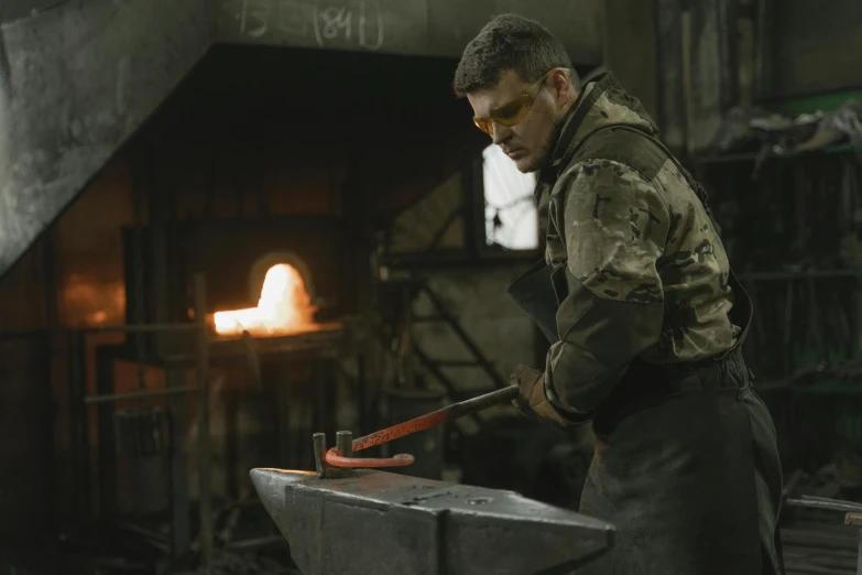 a man working on a piece of metal with a hammer, inspired by Jóhannes Sveinsson Kjarval, pexels contest winner, metal gear movie still, australian, casting fireball, thumbnail