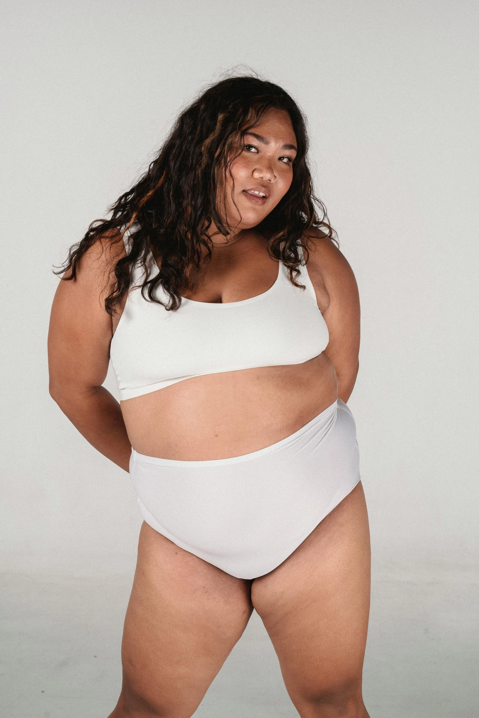 a woman in a white bikini posing for a picture, inspired by Weiwei, obese, non binary model, croptop, whitespace