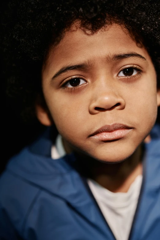 a close up of a child wearing a blue jacket, black man with afro hair, sad eyes, slide show, multiple stories
