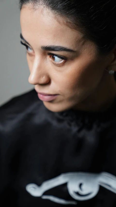 a woman getting her hair cut by a hair stylist, an album cover, by Louisa Matthíasdóttir, pexels contest winner, alexandria ocasio-cortez, portrait close - up, young middle eastern woman, androgynous person