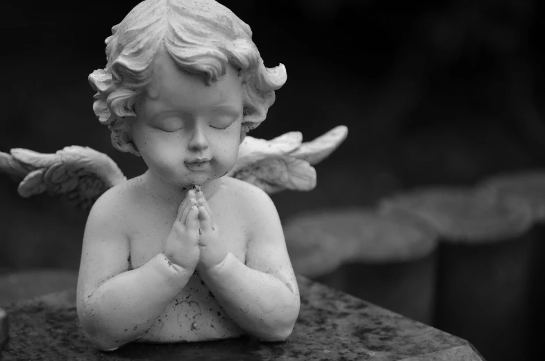 a black and white photo of a statue of a praying angel, pexels, cherub, biblically acurate angel, delightful surroundings, innocent look