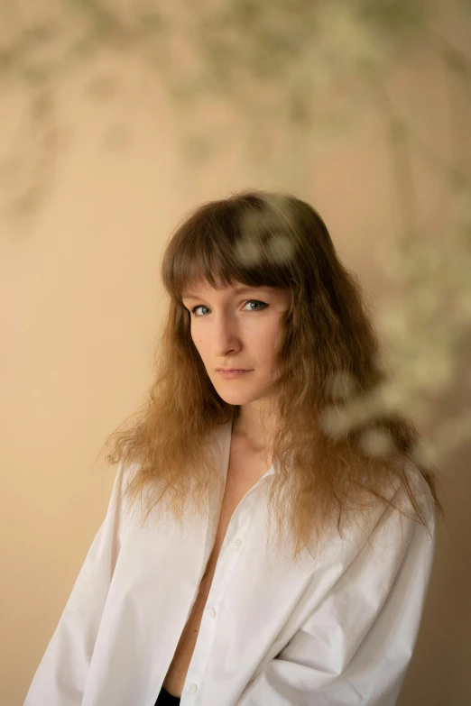 a woman in a white shirt posing for a picture, an album cover, inspired by Anna Füssli, bangs and wavy hair, portrait image, transparent, flowers in background