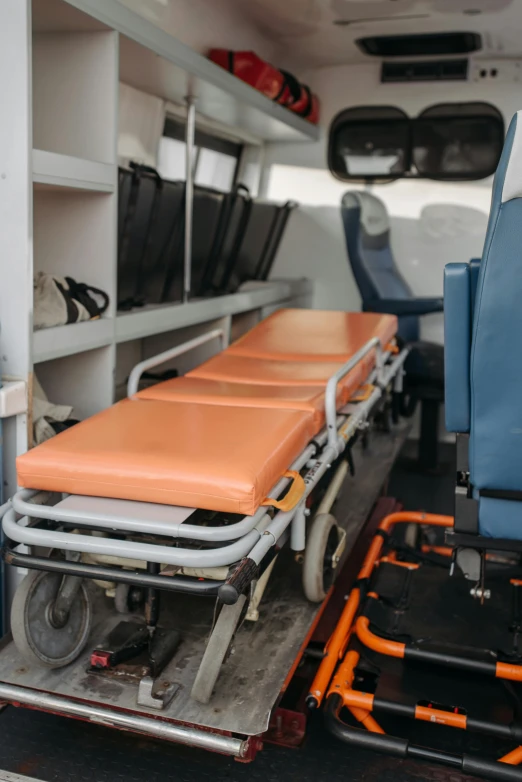 an ambulance with medical equipment in the back of it, by Andries Stock, pexels, avatar image, multiple stories, knee, brown