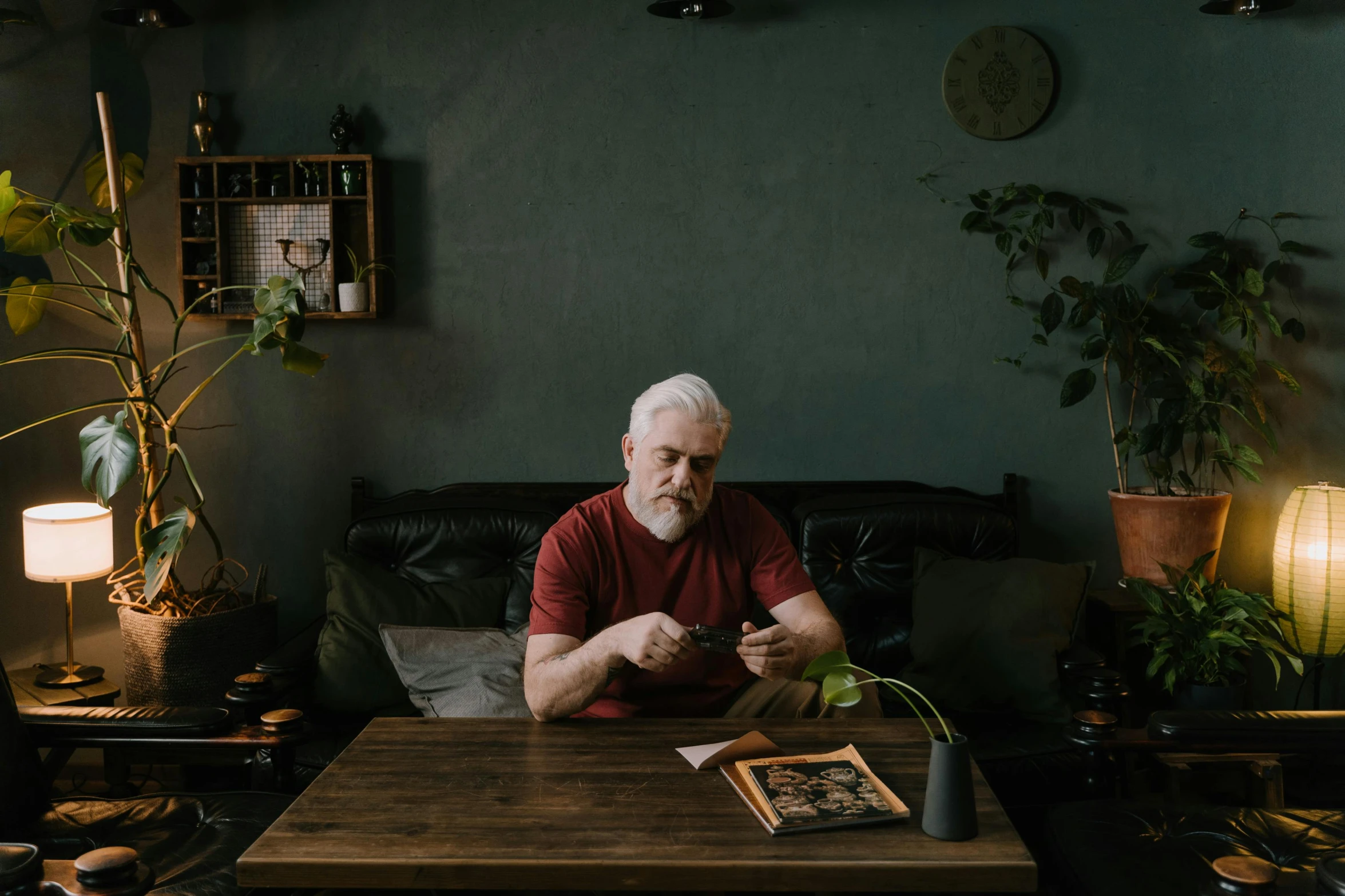 a man sitting at a table in a living room, a portrait, by Adam Marczyński, pexels contest winner, white beard, sitting on a mocha-colored table, 15081959 21121991 01012000 4k, having an awkward dinner date