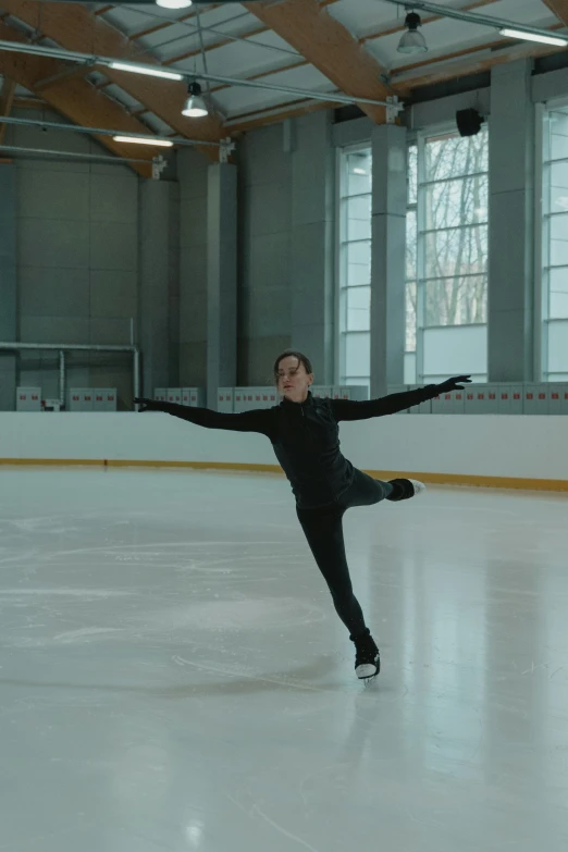 a man riding a skateboard on top of an ice rink, inspired by Judy Takács, arabesque, video still, **cinematic, full body image, andrea savchenko