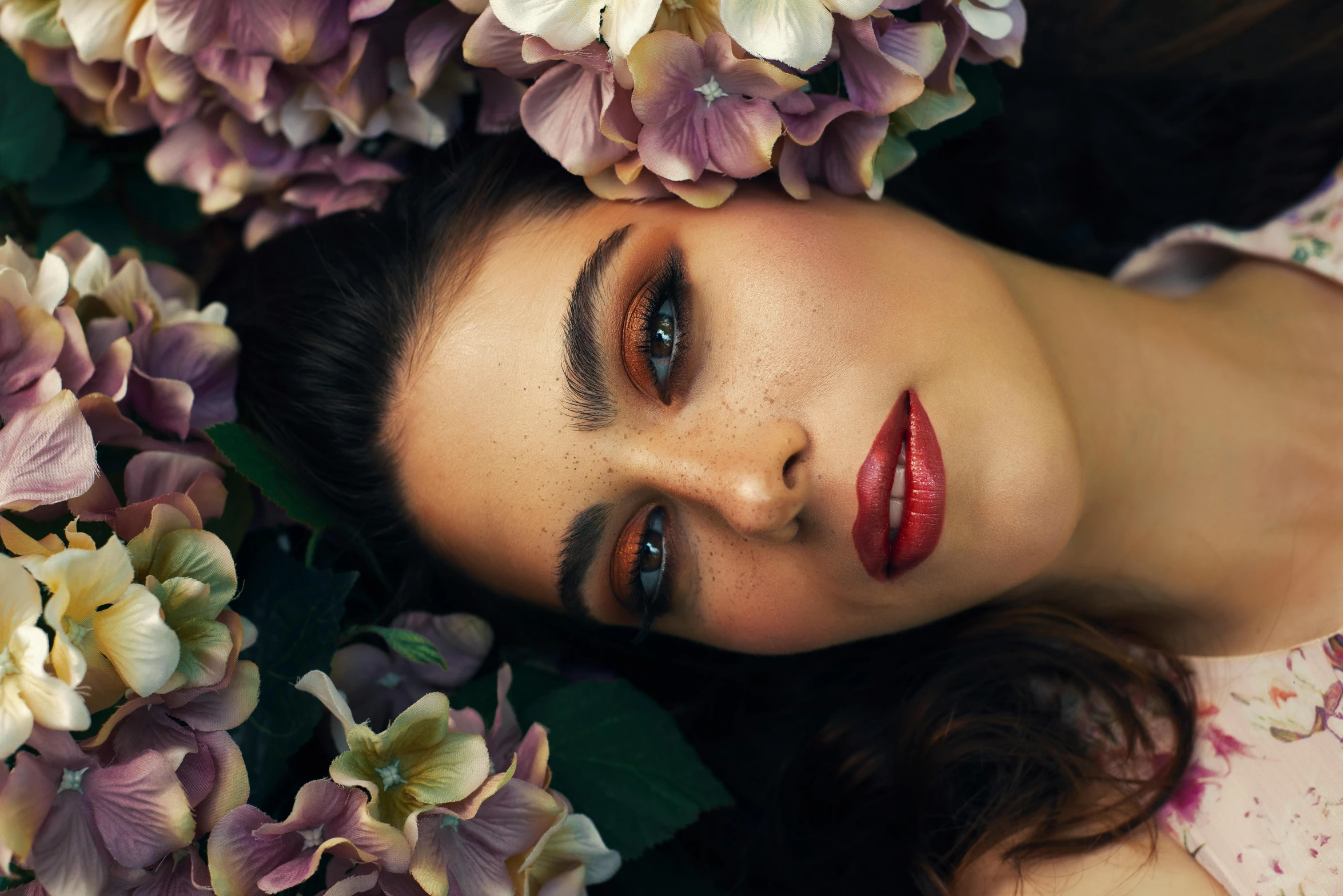 a woman laying on top of a bed of flowers, trending on pexels, hyperrealism, evening makeup, thick lips, large eyebrows, fashion portrait photo