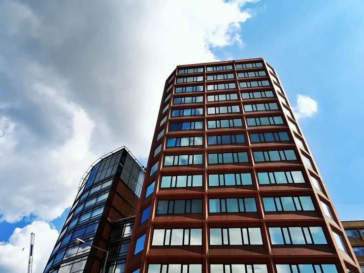 a couple of tall buildings sitting next to each other, inspired by Richard Wilson, unsplash, brutalism, clear blue skies, rusty metal towers, eyelevel perspective image, 2000s photo