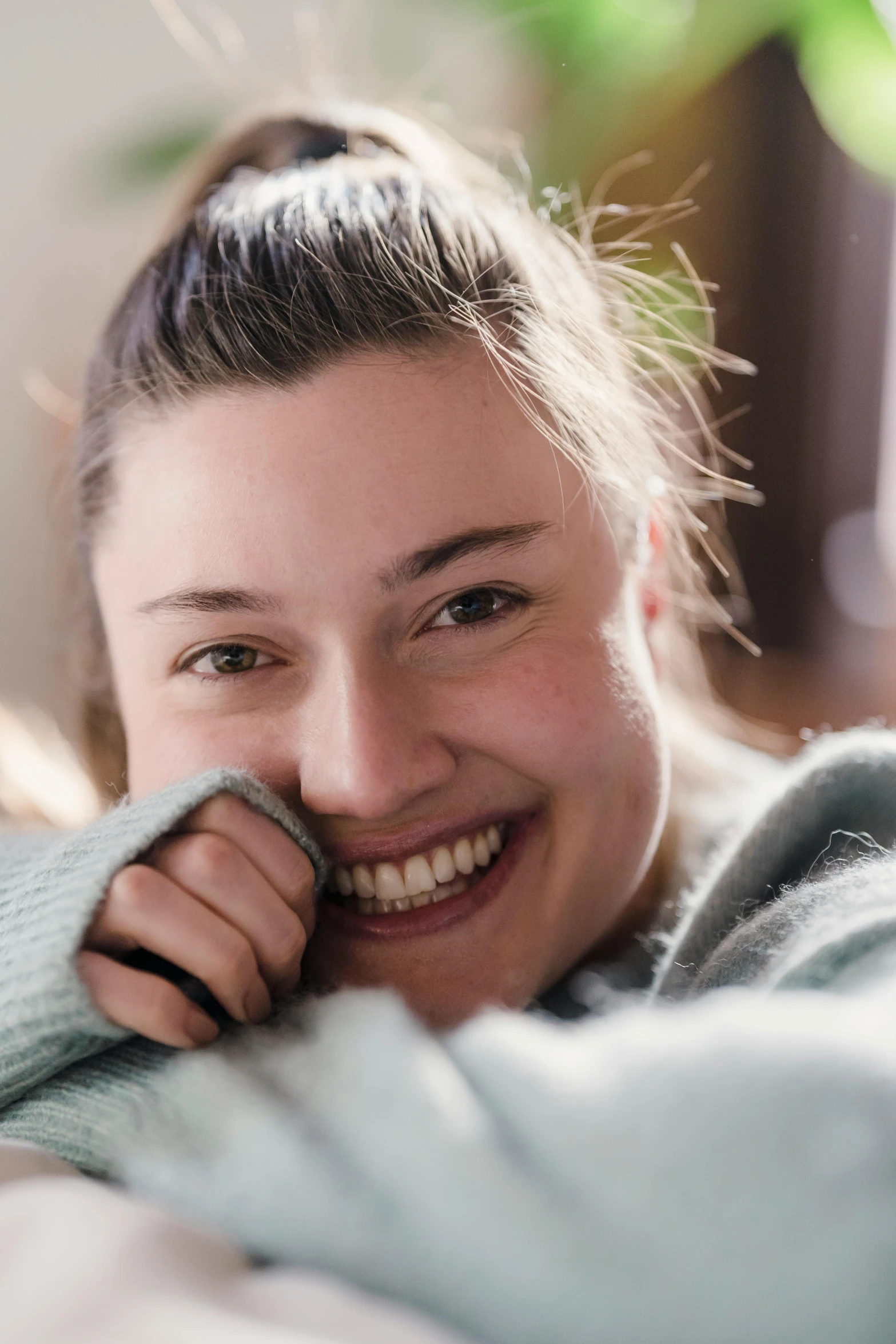 a close up of a person laying on a bed, inspired by Louisa Matthíasdóttir, shutterstock contest winner, happening, happily smiling at the camera, florence pugh, without makeup, phoebe tonkin