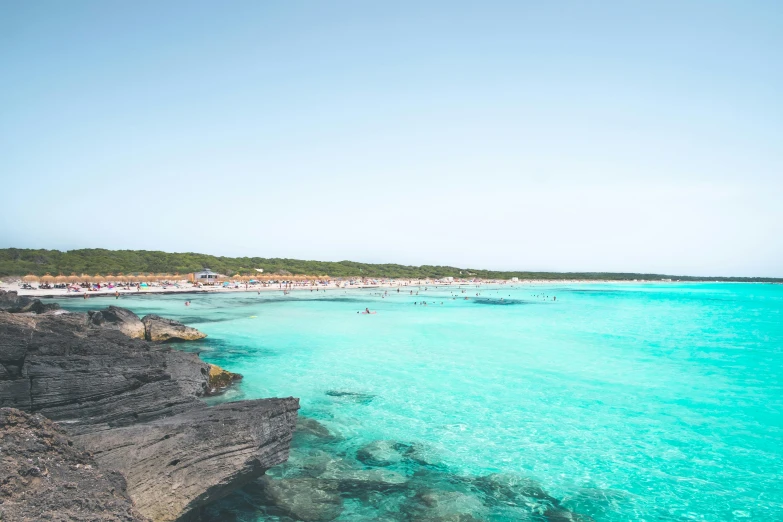 a large body of water next to a beach, pexels contest winner, figuration libre, apulia, carribean turquoise water, 2 0 5 6 x 2 0 5 6, crowded beach