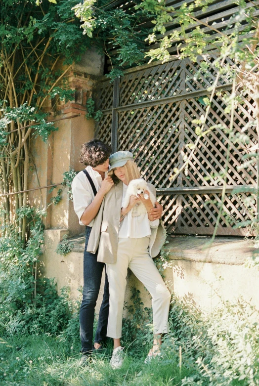 a man and a woman leaning against a wall, unsplash, renaissance, lush chic garden, medium format. soft light, animals, conde nast traveler photo