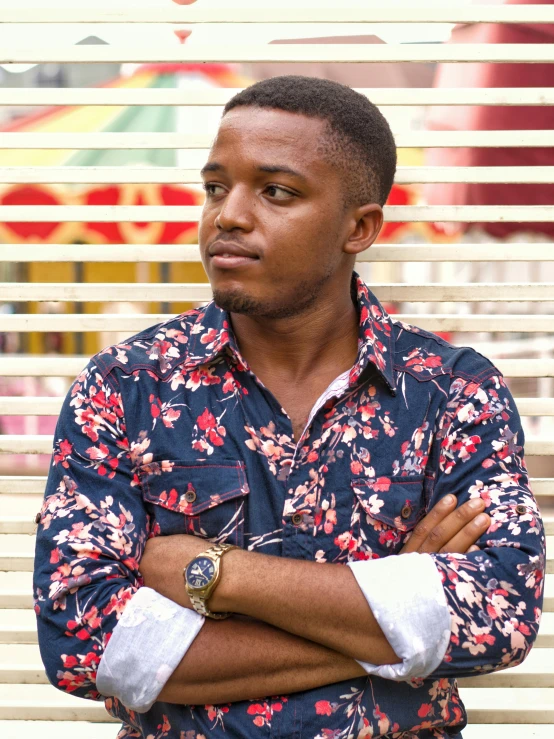 a man standing in front of a window with his arms crossed, an album cover, by Chinwe Chukwuogo-Roy, pexels contest winner, he is about 20 years old | short, with hawaiian shirt, wearing a fancy jacket, annoyed