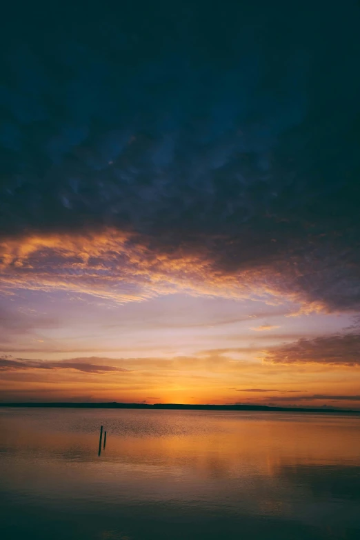 a large body of water with a sky in the background, a picture, during a sunset, film color photography, cinematic shot ar 9:16 -n 6 -g, medium-shot