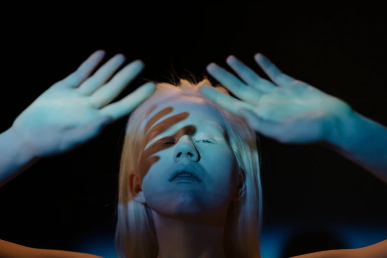 a woman with white paint on her face and hands, a hologram, unsplash, holography, extremely pale blond hair, looking upwards, avatar image, serge lutens