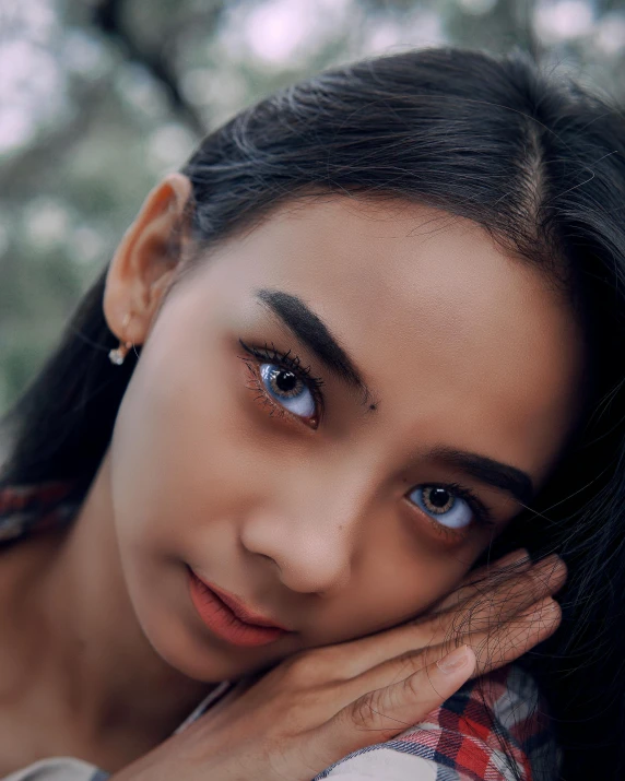 a close up of a woman with long hair, inspired by Sasha Putrya, trending on pexels, sumatraism, angular eyebrows, non binary model, lovingly looking at camera, mixed-race woman