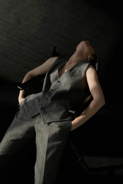 a man in a suit sitting on a chair, inspired by Fei Danxu, trending on cg society, woman very tired, in-game 3d model, lying down, suit vest