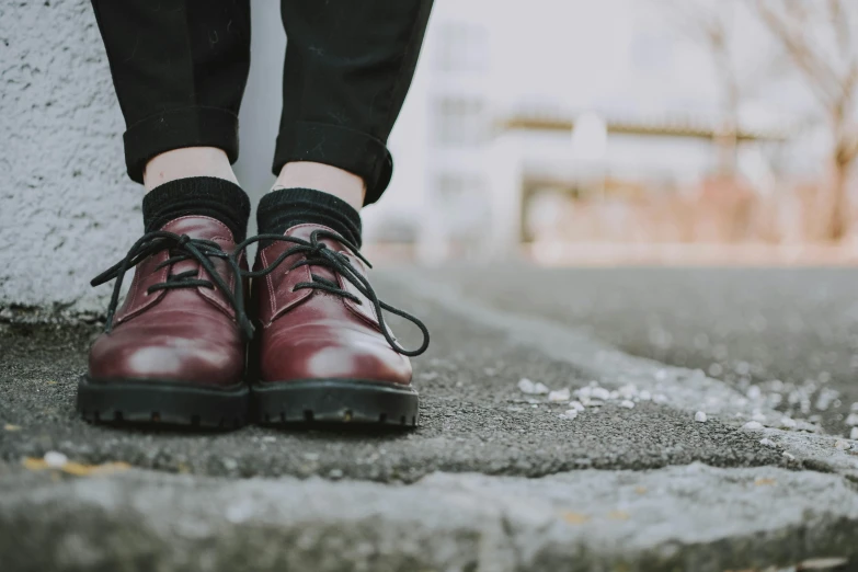 a close up of a person wearing a pair of shoes, trending on pexels, maroon accents, realistic », androgynous, background image