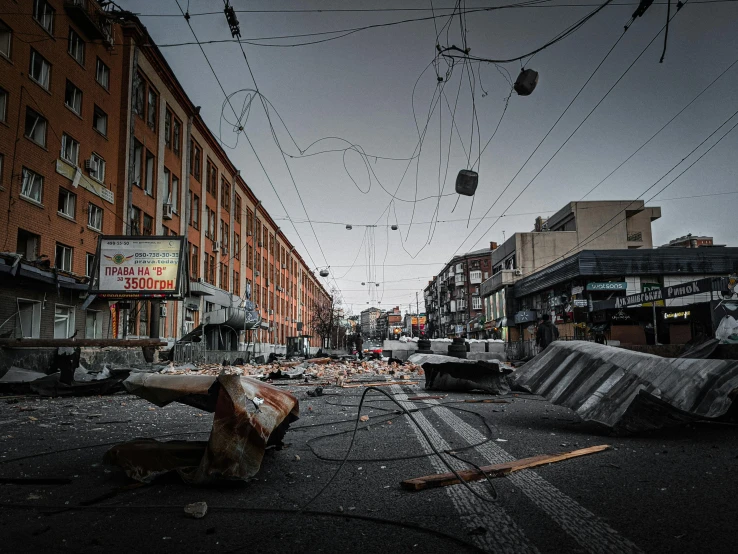 a street filled with lots of debris next to tall buildings, inspired by Simon Stålenhag, pexels contest winner, hyperrealism, norilsk, covered with wires, violent protest, liege