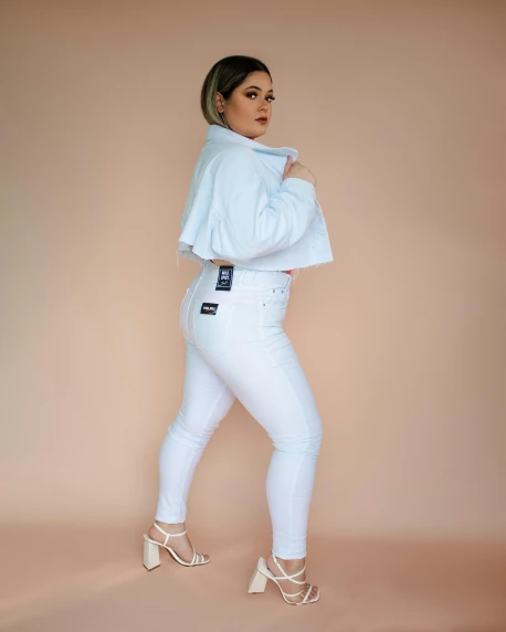 a woman in white is posing for a picture, wearing jeans, thicc, profile image, asher duran