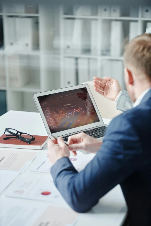 a man sitting at a table in front of a laptop computer, ui and ux, andrei ryabovichev, thumbnail, high quality image